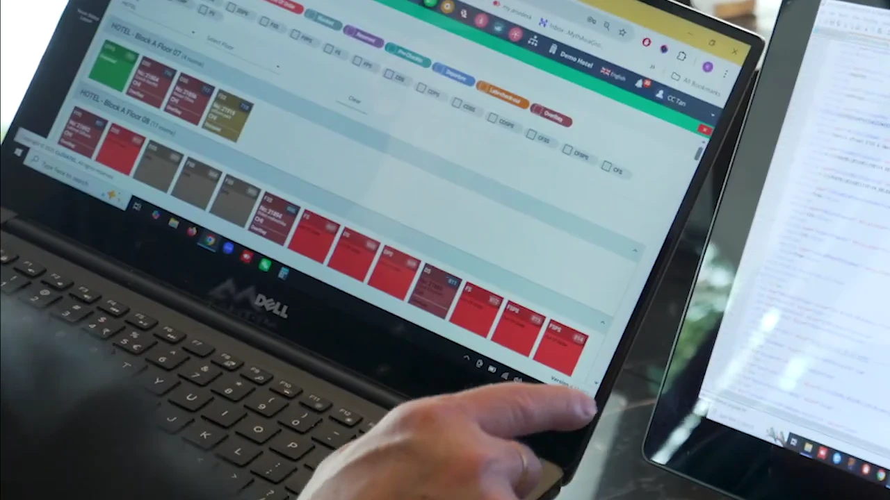 Hotel team reviewing live room status in a property management system
